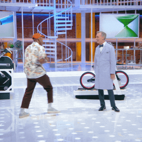 a man in a lab coat stands next to another man