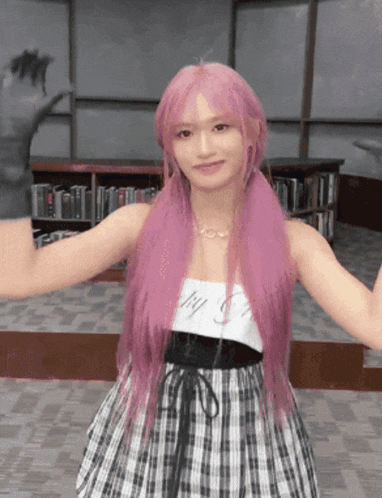 a girl with pink hair wearing a plaid dress