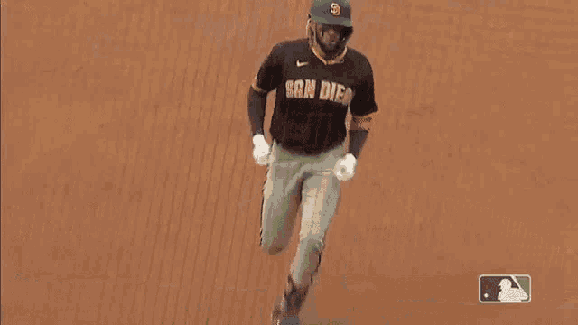 a baseball player with the number 11 on his back is running to base
