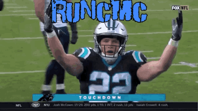 a football player with the number 22 on his jersey celebrates