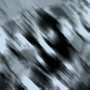 a black and white photo of a person 's face with a blurry background