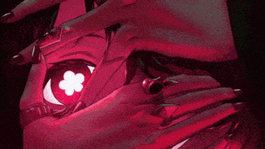 a close up of a person 's hand with a red eye