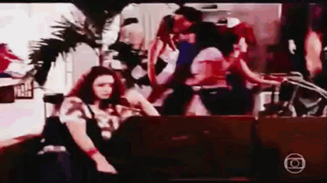 a group of people are dancing in a room with the letter o in the corner
