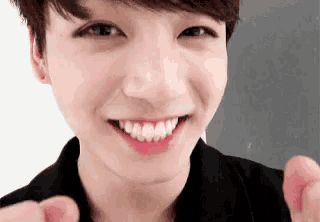 a close up of a young man 's face with a smile on his face .