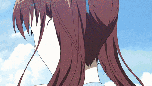 a close up of a woman 's face with a blue sky in the background