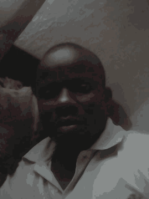 a man in a white shirt is taking a picture of himself