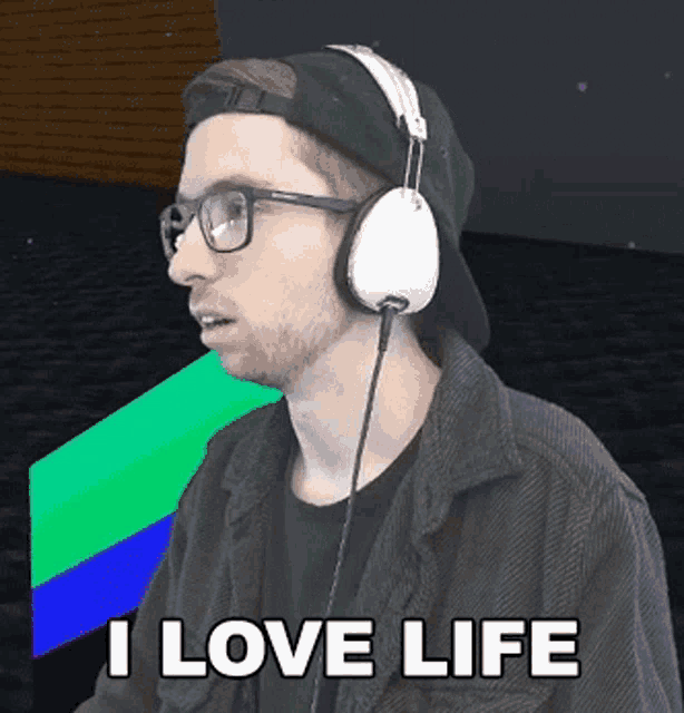 a man wearing glasses and headphones says i love life