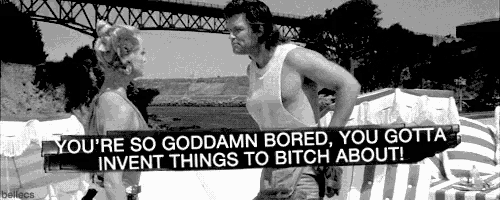 a black and white photo of a man and a woman with the caption " you 're so goddamn bored