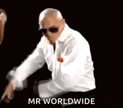 a man wearing sunglasses and a white shirt is sitting on a chair and says `` mr worldwide '' .