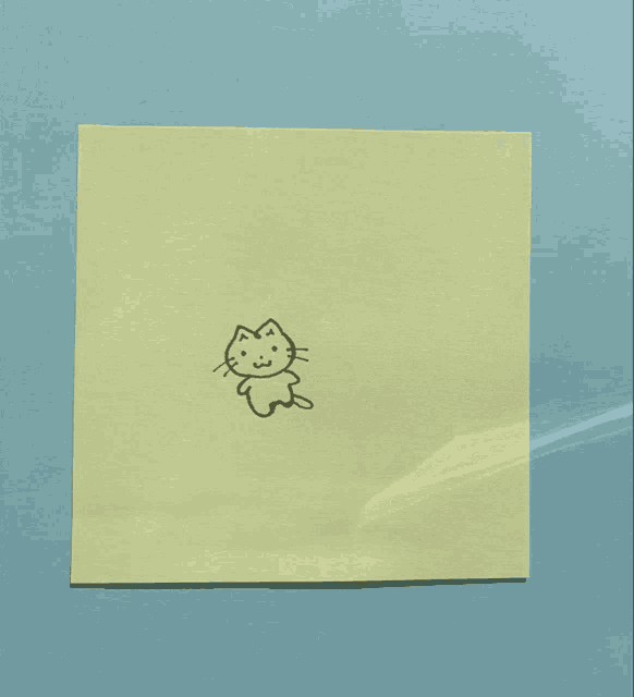 a drawing of a cat on a yellow piece of paper