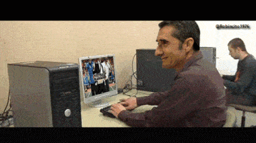a man is typing on a keyboard in front of a computer monitor that says ' star wars ' on it