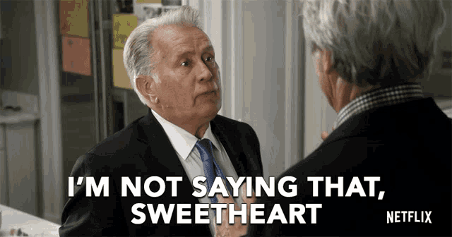 a man in a suit and tie says " i 'm not saying that sweetheart " to another man