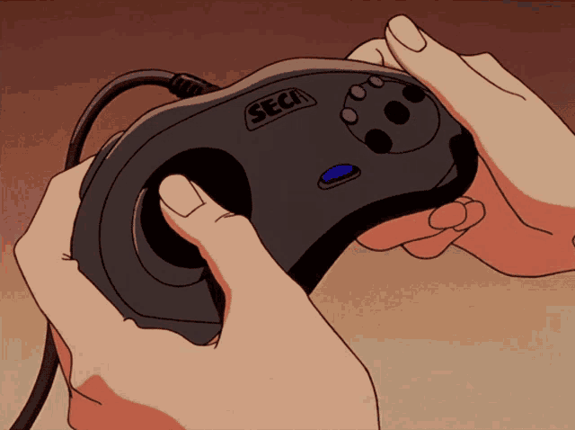 a person is holding a sega game controller in their hands