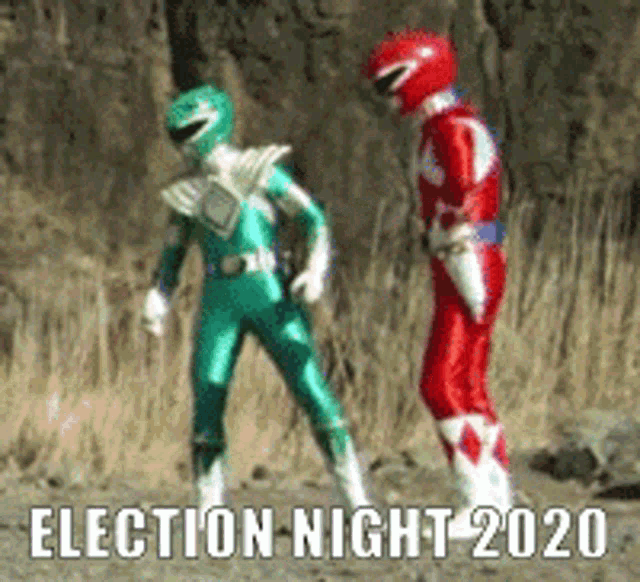 a green power ranger and a red power ranger are dancing in the dirt .