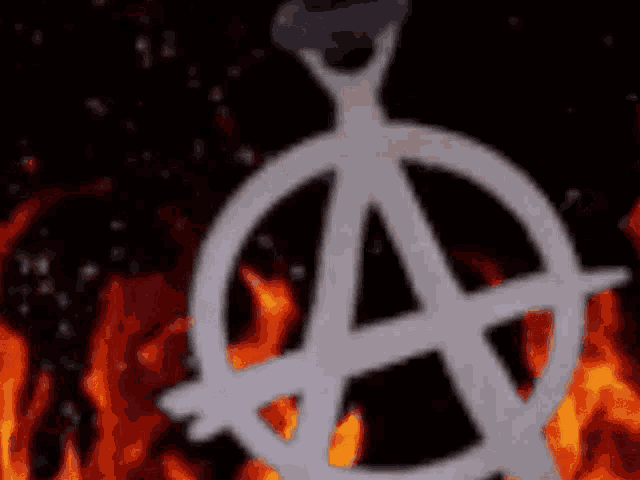 a white anarchy symbol is surrounded by flames on a black background