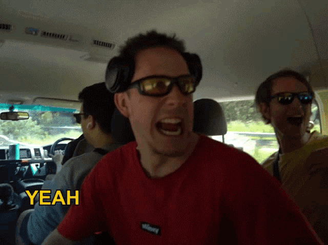 a man in a red shirt with the word yeah on the bottom