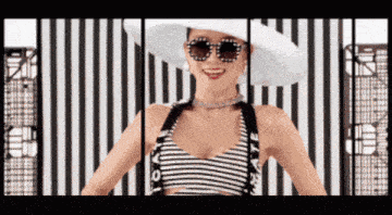 a woman wearing a white hat and sunglasses is standing in front of a striped wall