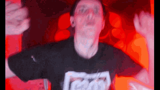 a man wearing a black shirt with the word coca cola on the front