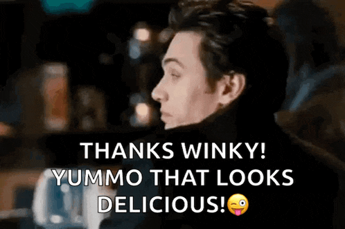 a man is making a funny face and saying thanks winky yummo that looks delicious .