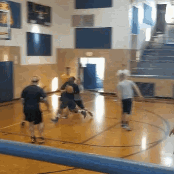 a group of men are playing basketball on a court