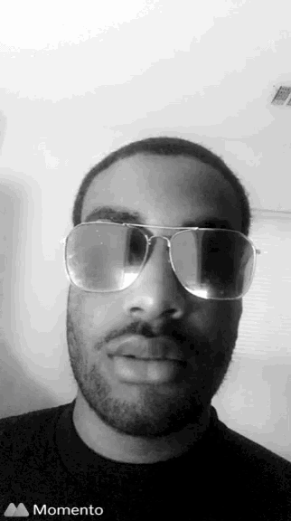 a black and white photo of a man wearing sunglasses with a momento icon below him