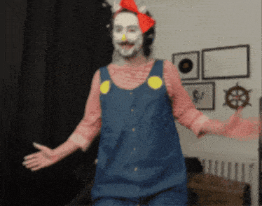 a man in a clown costume is dancing in a room