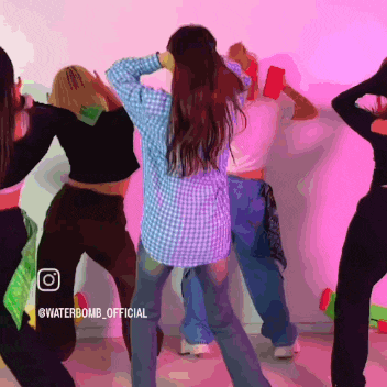 a group of women are dancing in front of a pink wall with the words waterbomb official on the bottom