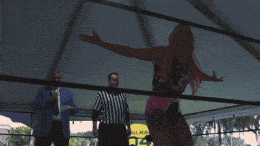 a woman in a wrestling ring with a shirt that says smackdown