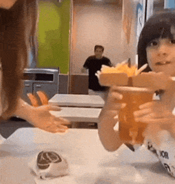 a little girl is holding a cup that says ' mcdonalds ' on it