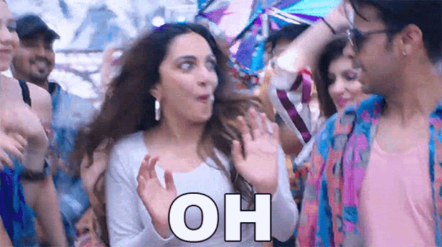 a woman is dancing in a crowd with the word oh written on the bottom