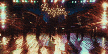 a group of people are dancing in front of a sign that says richie reggae