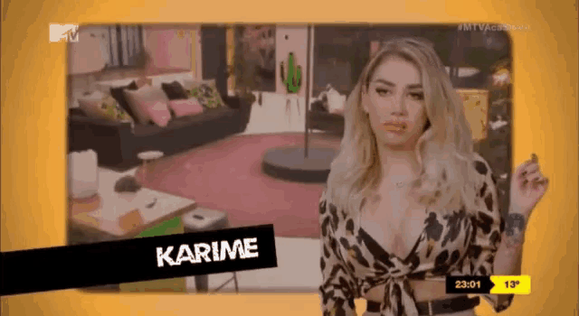 a woman in a leopard print top is standing in front of a screen that says karime