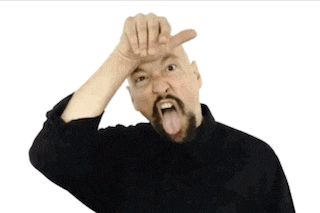 a bald man with a beard is sticking his tongue out