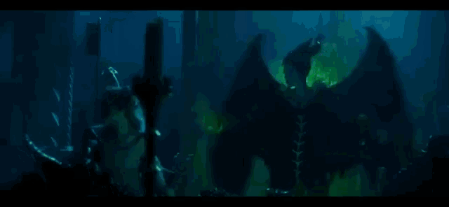 a demon with horns is flying through the air in a dark room with green flames .