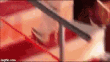 a close up of a person 's face with a red background and a sword in the background .