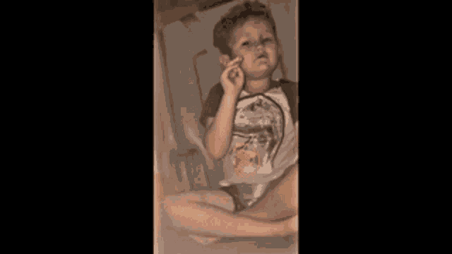 a young boy is crying behind a glass door and the words oh yeah baby are above him