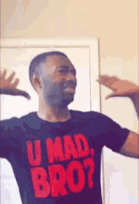 a man wearing a black shirt that says u mad bro on it