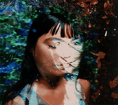 a pixelated image of a woman 's face surrounded by trees