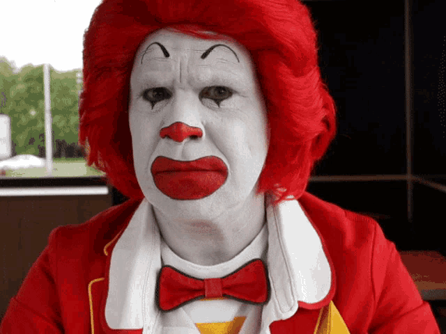 a man dressed as mcdonald 's clown with red hair