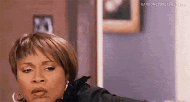 a woman with short hair is making a funny face in a living room .