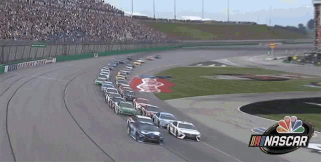 a bunch of cars are racing on a race track that says nascar
