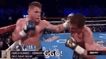 two men are boxing in a ring and one of them is wearing boxing gloves .