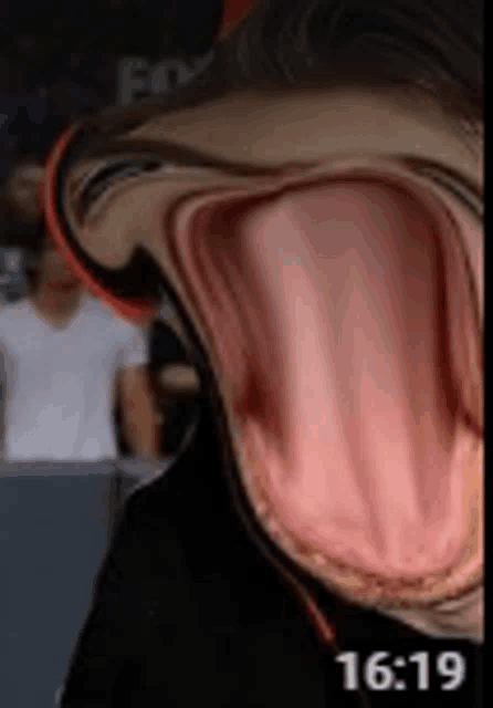 a close up of a person 's mouth with their tongue sticking out