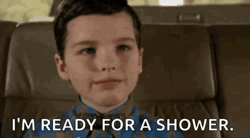 a young boy is sitting in a chair and says `` i 'm ready for a shower . ''