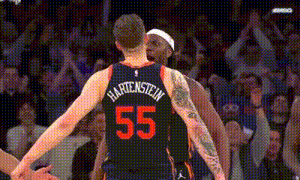 a basketball player with the number 55 on his jersey is standing next to another basketball player .