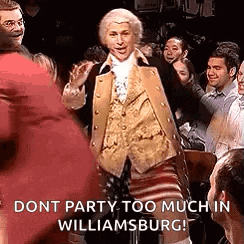a man in a costume is dancing in front of a crowd of people in williamsburg .