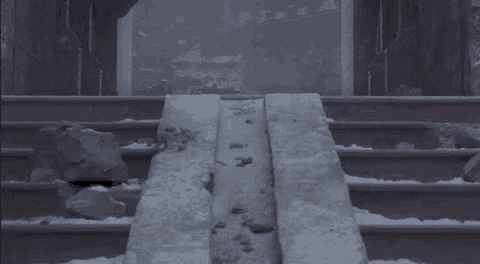 a snowy staircase with a few rocks on the steps
