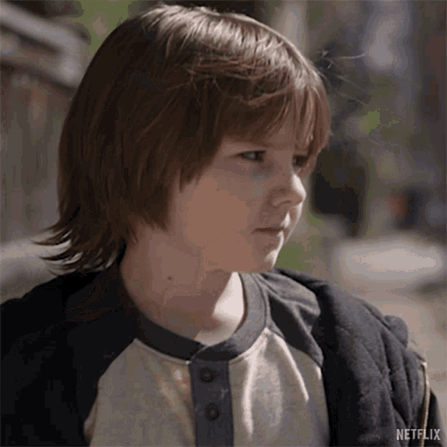 a close up of a young boy 's face with a netflix logo in the corner