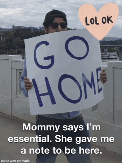 a man holds a sign that says go home