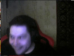 a blurry picture of a man wearing headphones and a black shirt